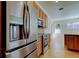 Stainless steel refrigerator and appliances in kitchen with light wood cabinets at 476 Denise St, Tarpon Springs, FL 34689