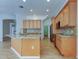 Bright kitchen features an island, granite counters, stainless appliances, and wood cabinets at 476 Denise St, Tarpon Springs, FL 34689