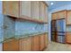 Light maple cabinets and stainless refrigerator in bright kitchen at 476 Denise St, Tarpon Springs, FL 34689