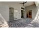 Outdoor brick paved patio with ceiling fan and sliding glass doors to the house at 476 Denise St, Tarpon Springs, FL 34689