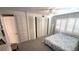 Bedroom with shuttered windows, closets, and neutral carpet at 4851 W Gandy Blvd # B12L28, Tampa, FL 33611
