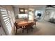 Dining area with shuttered windows and a peek into the kitchen area at 4851 W Gandy Blvd # B12L28, Tampa, FL 33611