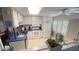 Bright kitchen featuring white cabinets, appliances, and blue countertops, creating a cheerful cooking environment at 4851 W Gandy Blvd # B12L28, Tampa, FL 33611