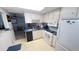 Cozy kitchen with white cabinets, appliances, and blue countertops, providing a functional and inviting space at 4851 W Gandy Blvd # B12L28, Tampa, FL 33611