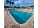 Community pool with clear blue water and poolside lounge chairs at 4851 W Gandy Blvd # B12L28, Tampa, FL 33611