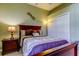 This cozy bedroom features a dark wood bed, night stand, closet and a window at 522 Planters Manor Way, Bradenton, FL 34212