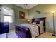 This cozy bedroom features a dark wood bed, night stand, and a window with natural light at 522 Planters Manor Way, Bradenton, FL 34212