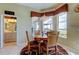 Bright breakfast nook with bay windows overlooking the backyard and access to the bathroom at 522 Planters Manor Way, Bradenton, FL 34212