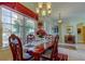 Formal dining room features a large window, stylish furnishings, and neutral paint, creating a great ambiance at 522 Planters Manor Way, Bradenton, FL 34212
