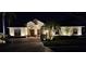 Stunning home exterior at night featuring lush landscaping, inviting lighting, and an elegant facade at 522 Planters Manor Way, Bradenton, FL 34212