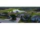 A charming home nestled in a picturesque neighborhood with lush greenery, a tranquil pond, and a nearby golf course at 522 Planters Manor Way, Bradenton, FL 34212