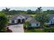 Beautiful single-story home showcasing manicured landscaping, elegant architecture, and a serene pond view at 522 Planters Manor Way, Bradenton, FL 34212