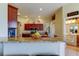 A stylish kitchen featuring granite countertops and dark wood cabinetry, plus views of the connecting rooms at 522 Planters Manor Way, Bradenton, FL 34212