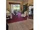 Comfortable living room featuring a plush rug and scenic views of the outdoor space at 522 Planters Manor Way, Bradenton, FL 34212