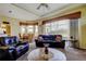 Spacious living room boasts large windows, comfortable seating, and an open layout to the dining area at 522 Planters Manor Way, Bradenton, FL 34212