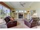 Comfortable living room features large windows, a ceiling fan, and a built-in entertainment center at 522 Planters Manor Way, Bradenton, FL 34212