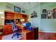 Office boasts hardwood floors, a ceiling fan, built-in shelves, and dual desk space for productivity at 522 Planters Manor Way, Bradenton, FL 34212