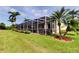 Enclosed patio area offers outdoor living space with lush landscaping and well-manicured lawn at 522 Planters Manor Way, Bradenton, FL 34212