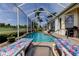 Inviting screened pool area with poolside lounge chairs and views of the golf course at 522 Planters Manor Way, Bradenton, FL 34212