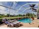 Screened pool area with lounge chairs and a view of the lush golf course at 522 Planters Manor Way, Bradenton, FL 34212