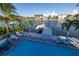 Aerial shot of backyard pool with patio and lounge seating showcasing a waterfront location with boat dock and canal at 533 Lillian Dr, Madeira Beach, FL 33708