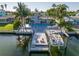 Stunning waterfront home featuring a private boat dock, boat lift, pool, and outdoor entertaining spaces at 533 Lillian Dr, Madeira Beach, FL 33708