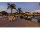 Enjoy the intercoastal view from this home's balcony with string lights, palms, and a table with seating at 533 Lillian Dr, Madeira Beach, FL 33708