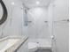 Modern bathroom with granite counters, updated fixtures, glass shower, and an elegant design at 533 Lillian Dr, Madeira Beach, FL 33708