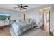 Bedroom with a ceiling fan, TV, and wood-look tile floors, perfect for relaxing and unwinding at 533 Lillian Dr, Madeira Beach, FL 33708