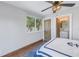 Bedroom features wood floors, ceiling fan and ensuite bath at 533 Lillian Dr, Madeira Beach, FL 33708
