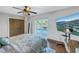 Bedroom offers water view, TV, wood floors, and closet with rustic doors at 533 Lillian Dr, Madeira Beach, FL 33708