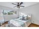 Bright bedroom featuring a ceiling fan, large window, and comfortable bedding at 533 Lillian Dr, Madeira Beach, FL 33708