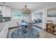 Dining room with modern chandelier and seamless flow to the other rooms at 533 Lillian Dr, Madeira Beach, FL 33708