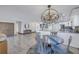 Chandelier illuminates dining area seamlessly connected to kitchen and living spaces at 533 Lillian Dr, Madeira Beach, FL 33708
