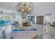 Bright dining area with chandelier and easy transition to outdoor entertaining at 533 Lillian Dr, Madeira Beach, FL 33708