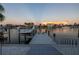 Beautiful view from the dock of the canal, with a boat lift and seating on the dock at 533 Lillian Dr, Madeira Beach, FL 33708