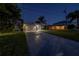 Charming home exterior showcasing a well-manicured lawn and two-car garage with adjacent homes and landscaping at 533 Lillian Dr, Madeira Beach, FL 33708