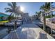 Backyard view with a boat dock, lift, waterfront access, and a second story deck with furniture at 533 Lillian Dr, Madeira Beach, FL 33708