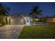 Well-maintained home exterior with a two-car garage, landscaped yard, and a welcoming front entrance at 533 Lillian Dr, Madeira Beach, FL 33708