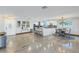 Open kitchen and dining area with a center island, modern lighting, and sleek countertops at 533 Lillian Dr, Madeira Beach, FL 33708