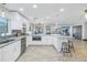 Open kitchen with granite island, stainless appliances, and seamless access to living spaces at 533 Lillian Dr, Madeira Beach, FL 33708