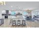 Bright kitchen with a large island, white cabinets, stainless steel appliances, and a dining area at 533 Lillian Dr, Madeira Beach, FL 33708