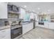 Spacious kitchen with stainless steel appliances, stylish backsplash, and modern lighting at 533 Lillian Dr, Madeira Beach, FL 33708