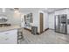 Modern kitchen featuring stainless steel appliances, granite counters, and a stylish console table at 533 Lillian Dr, Madeira Beach, FL 33708