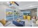 Bright living room with expansive pool and water views, a cozy seating arrangement at 533 Lillian Dr, Madeira Beach, FL 33708