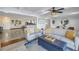 Comfortable living room with gray sofas, decorative pillows, and stylish decor, adjacent to the open kitchen at 533 Lillian Dr, Madeira Beach, FL 33708