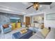 Bright living room featuring modern furnishings, a ceiling fan, and an entertainment center at 533 Lillian Dr, Madeira Beach, FL 33708