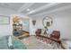 Cozy seating area with two leather chairs, a round mirror, and view of the dining room at 533 Lillian Dr, Madeira Beach, FL 33708