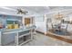 Living room showcasing an open floor plan with dining area, modern furniture, and a surfboard table at 533 Lillian Dr, Madeira Beach, FL 33708