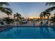 Backyard pool with waterfront views, palm trees, and a dock at 533 Lillian Dr, Madeira Beach, FL 33708